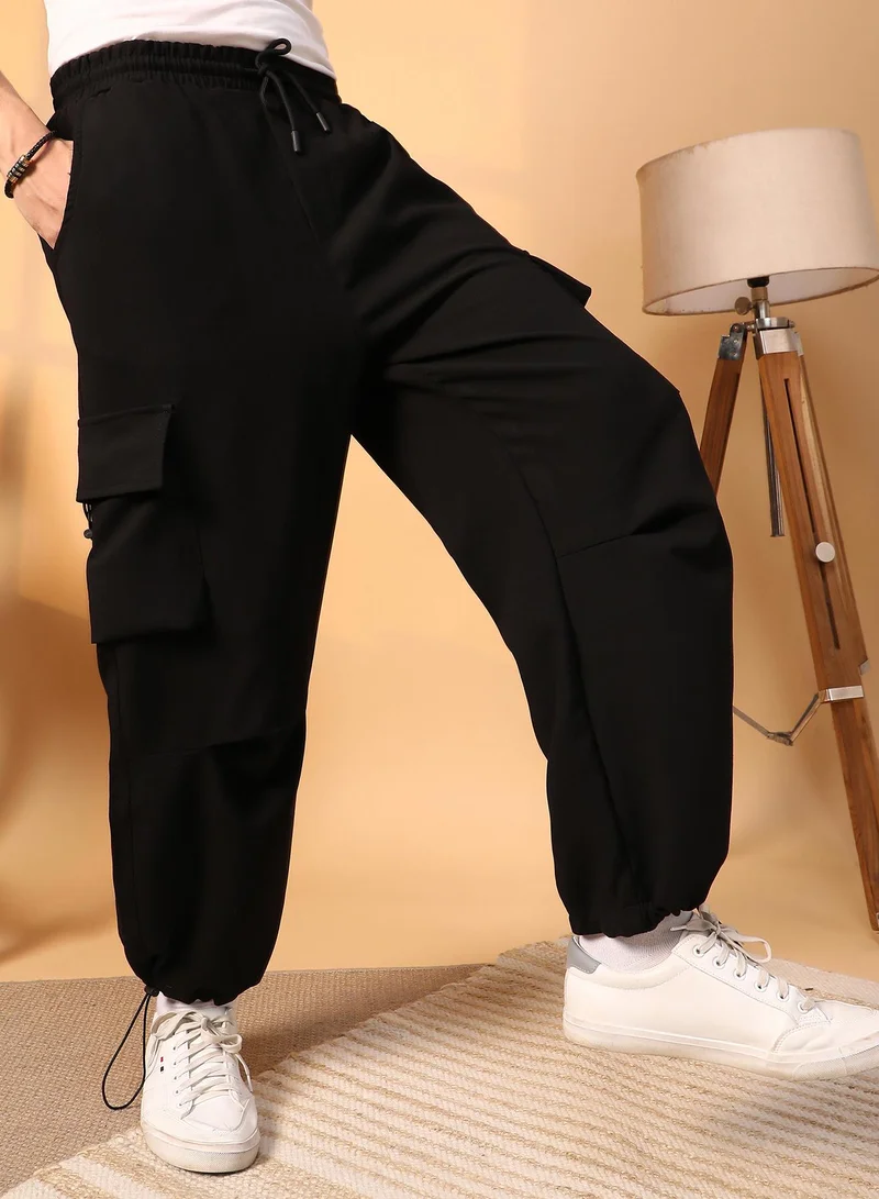 كامبوس سوترا Men's Onyx Black Solid Cargo Parachute Trousers For Casual Wear | 4 Pockets | Mid-Rise | Button Closure | Cargo Pants Crafted With Comfort Fit For Everyday Wear